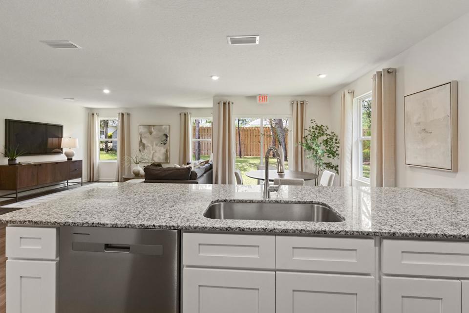A large kitchen with marble counters.