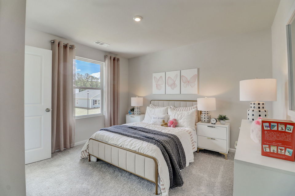 A bedroom with a large window.