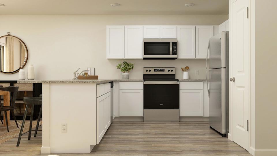 A kitchen with white cabinets.