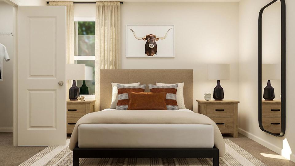 A bedroom with a bed and lamps.