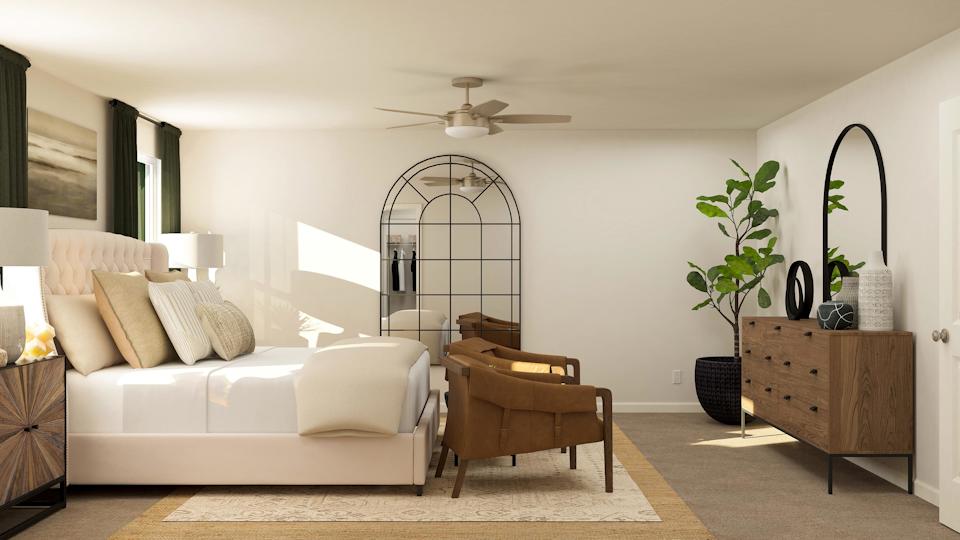 A living room with a white couch and a white table.