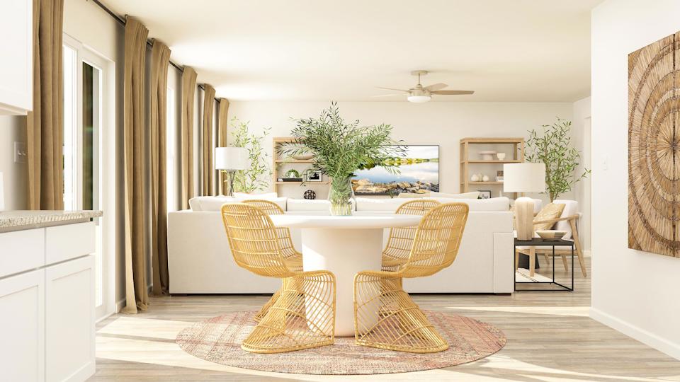 A living room with a table and chairs.