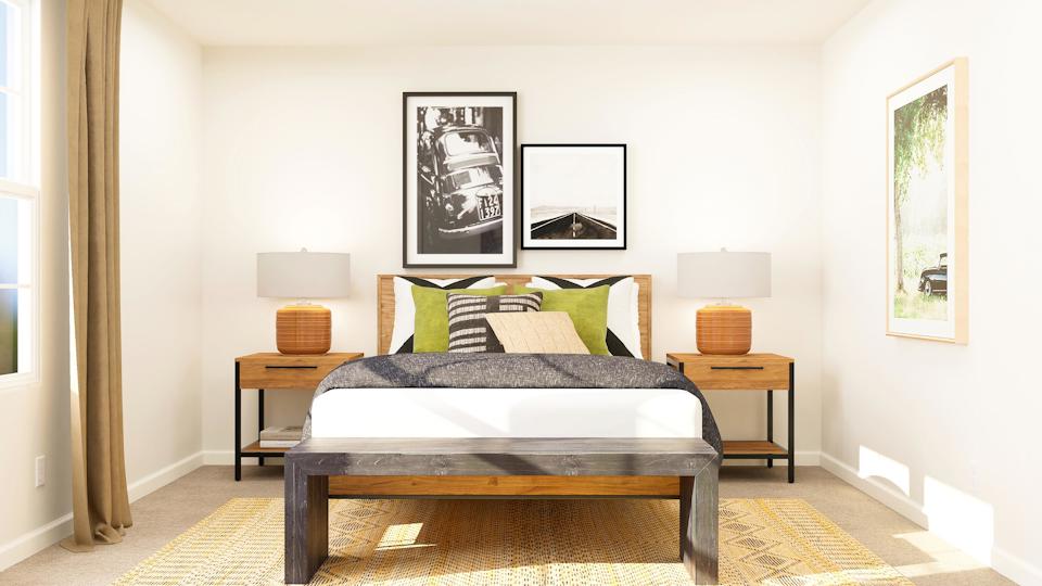 A bedroom with a bed and a table.