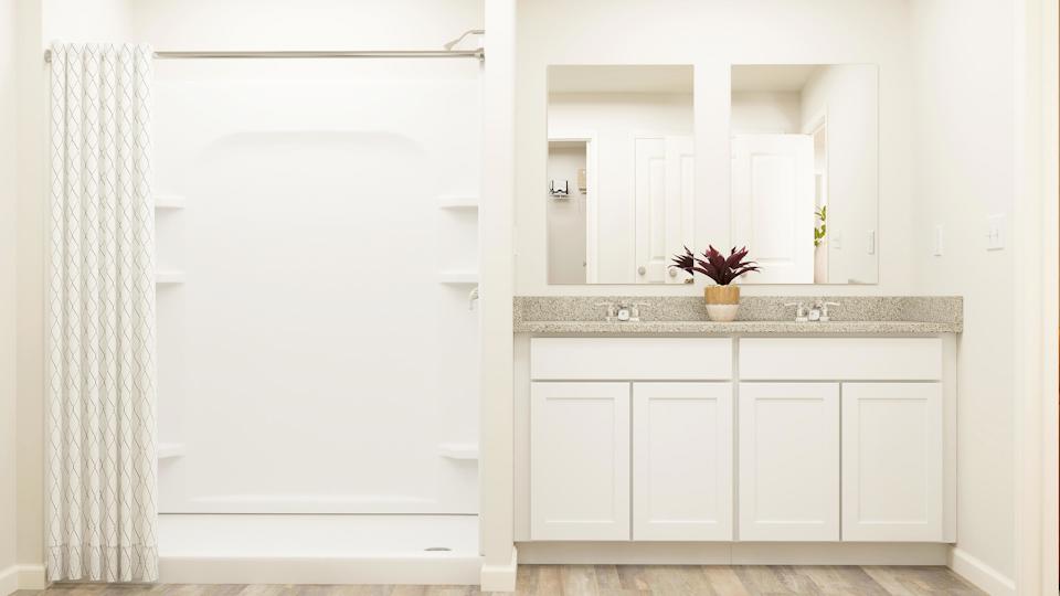 A white kitchen with a glass door.
