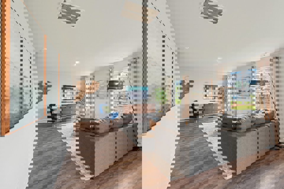 A living room with a couch and a tv.