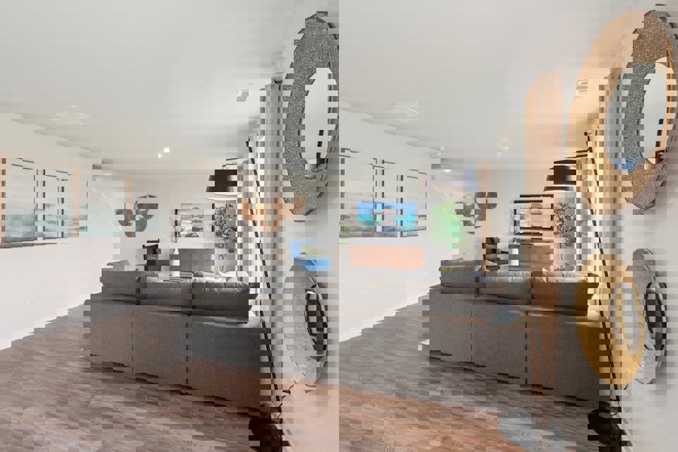 A living room with a large mirror.