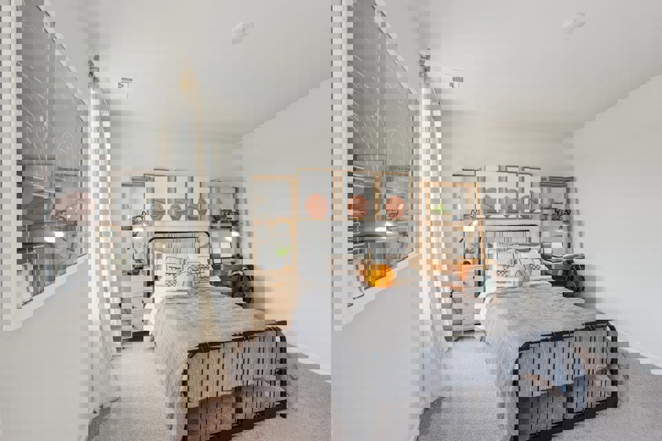 A bedroom with a bed and a mirror.