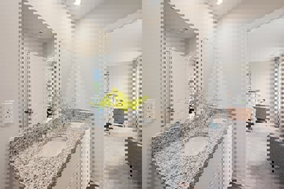 A bathroom with a marble countertop.