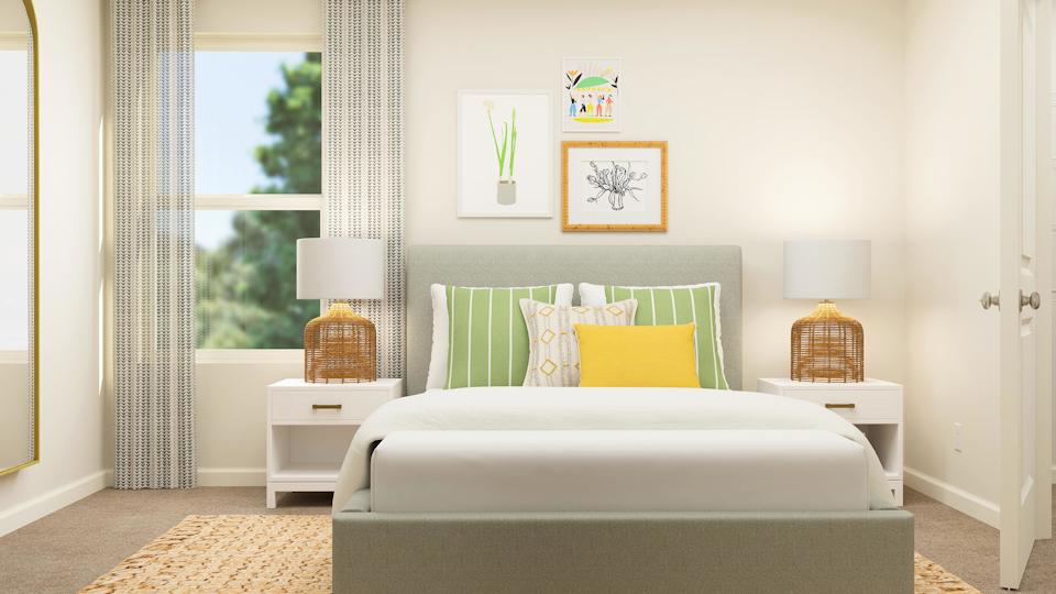 A room with a couch and a table with a lamp on it.