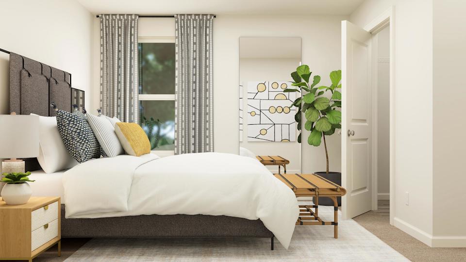 A bedroom with a bed and a table.