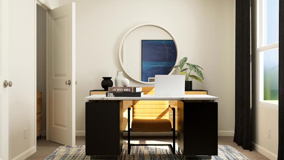 A desk with a laptop on it.