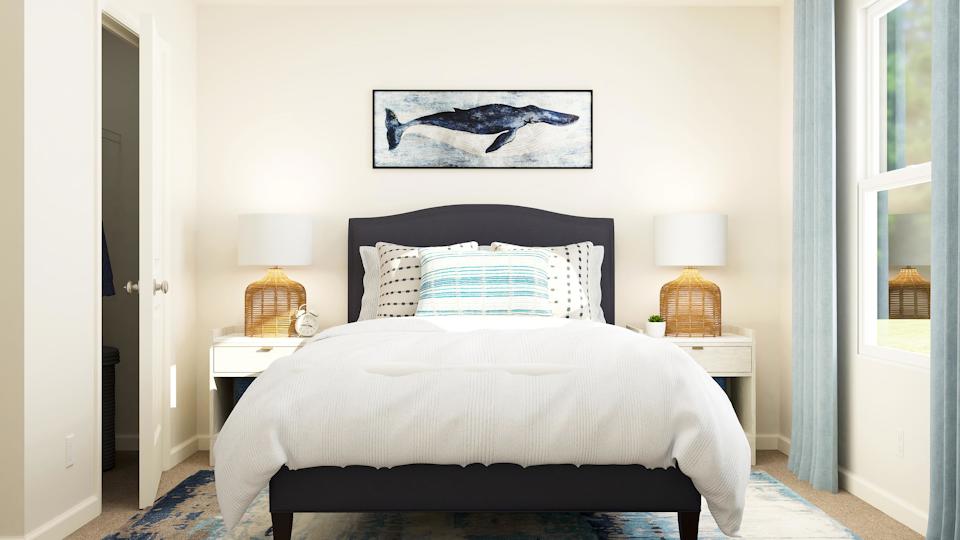 A bed with a white bed spread.