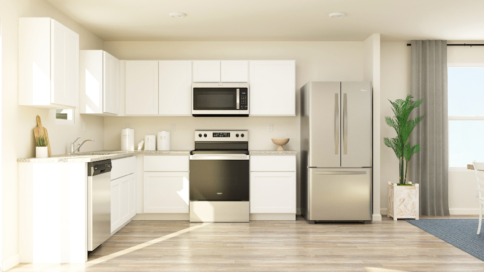 A kitchen with white cabinets.