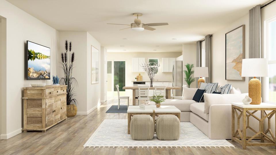 A living room with a white couch and a table.