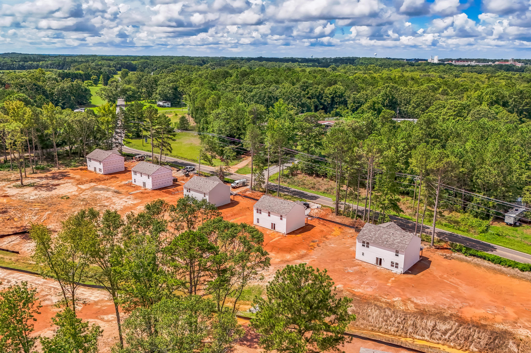 A group of buildings surrounded by trees.