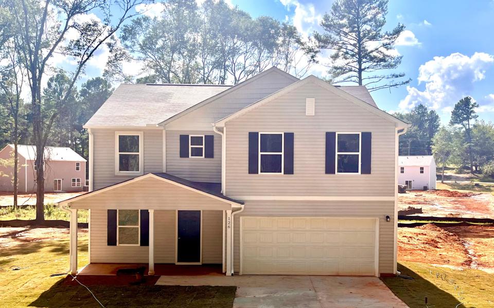 A white house with a garage.