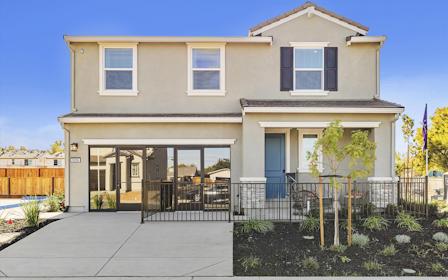 A house with a fence and trees.