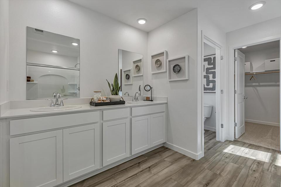 A bathroom with white cabinets.