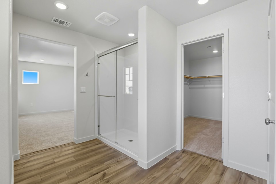 A room with a glass shower.